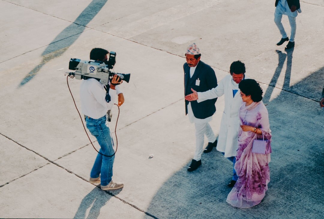Photographers with cameras and flashes at a red carpet event