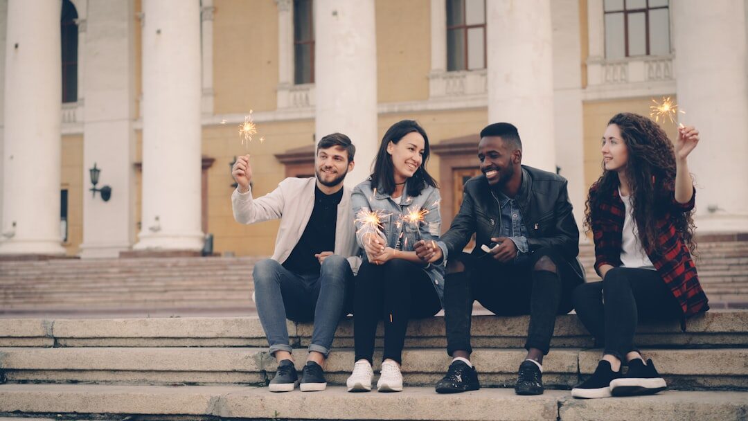 Group of friends reading news together on a phone outdoors
