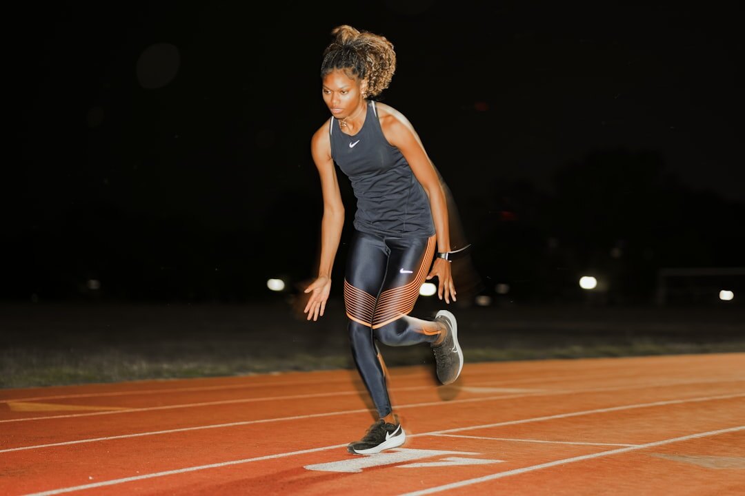 olympic runner stretching on track