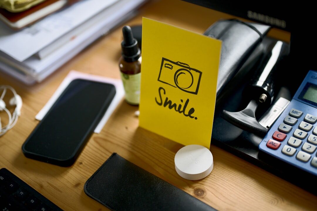 Professional camera and press pass on a wooden desk